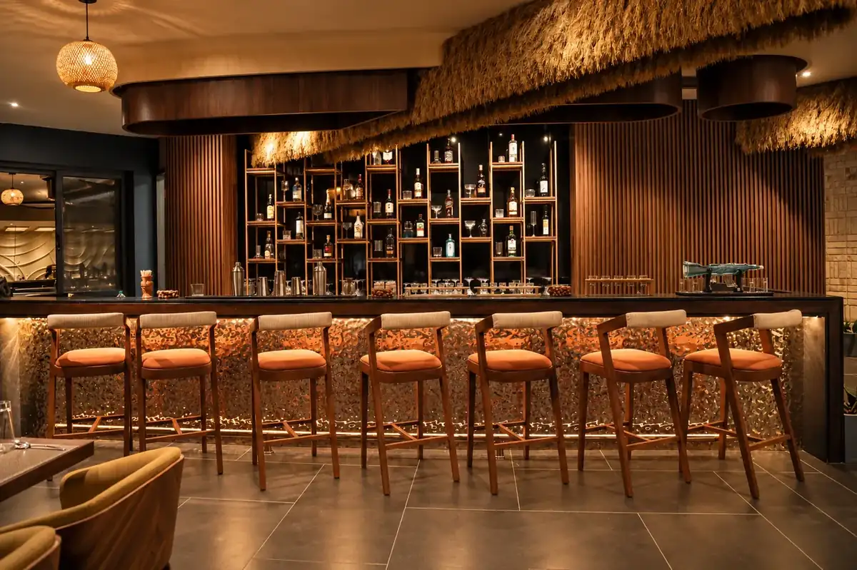 Breeze Point rooftop restobar counter with high barstools and custom backlit bar display